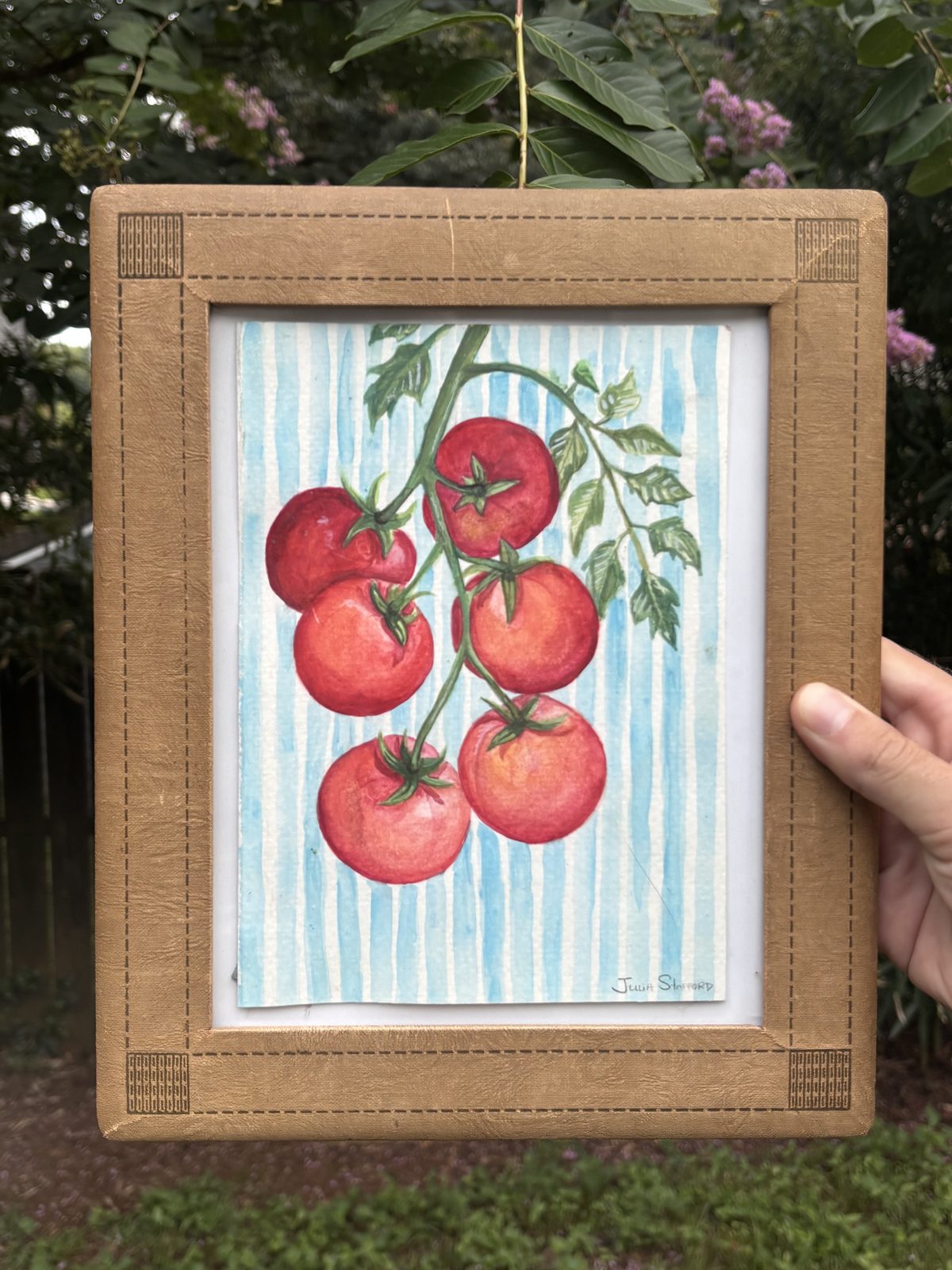 Ripe red tomatoes on the vine against a striped blue background, original watercolor in a vintage gold frame